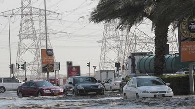 Motorists heading towards Ibn Battuta Mall negotiating waterlogged streets. Jeffrey E Biteng / The National