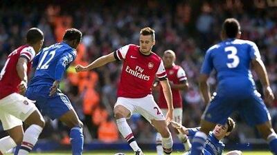 Arsenal's Carl Jenkinson, centre, employs his passing skills during a match against Chelsea in the English Premier League last month. Adrian Dennis / AFP