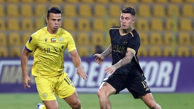 Al Wasl's Fabio Lima battles with Al Sadd's Cristo Gonzalez in a 1-1 draw in Dubai.