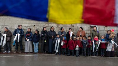 Exile Tibetans wait to welcome their spiritual leader the Dalai Lama on the last day of a three-day religious conference in Dharmsala, India. AP