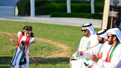 A girl dances to traditional Emirati music by Al Mazyood Band at a National Day event at Mohammed bin Rashid Library, next to Dubai Creek. All photos: Khushnum Bhandari / The National