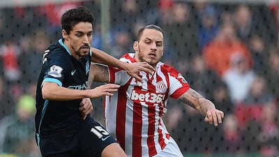 Manchester City’s Spanish midfielder Jesus Navas (L) vies with Stoke City’s Austrian striker Marko Arnautovic during the English Premier League football match between Stoke City and Manchester City at the Britannia Stadium in Stoke-on-Trent, central England on December 5, 2015. AFP PHOTO / PAUL ELLIS