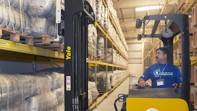 Ali Goahr, a forklift operator for the United Nations World Food Programme, moves blankets in the World Food Programme Warehouse in International Humanitarian City, Dubai. Kevin J. Larkin / The National