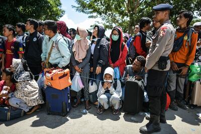 Residents wait behind a line before boarding military airplanes for evacuations at the Mutiara SIS Al Jufrie Airport in Palu. AFP