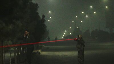 Afghan security officials take up positions near the scene of an attack by armed men at an upscale hotel in Kabul, Afghanistan. Jawad Jalali / EPA