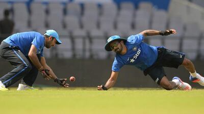 India's Cheteshwar Pujara (L) and Lokesh Rahul attempts to catch a ball during a training session ahead of the third Test cricket match between India and South Africa at The Vidarbha Cricket Association Stadium in Nagpur on November 24, 2015. AFP PHOTO / Indranil MUKHERJEE---- IMAGE RESTRICTED TO EDITORIAL USE - STRICTLY NO COMMERCIAL USE ----