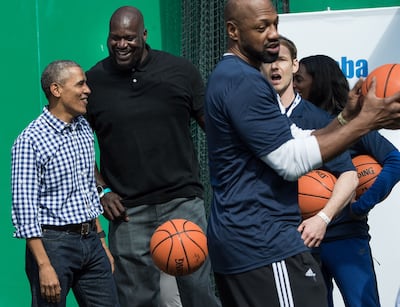 Barack Obama, then aged 54, jokes with former NBA basketball player Shaquille O'Neal at the White House's Easter Egg Roll in 2016. AFP