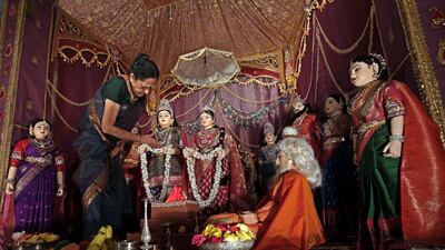 A woman gives finishing touches to dolls arranged in the theme of 'Ramayana', the ancient Indian epic, and displayed at the Karnataka Chitrakala Parishath gallery as part of the Navratri festival in Bangalore. EPA