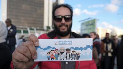 A man shows his electoral card during a protest against the postponement of the Libyan presidential election initially planned for December 24, 2021, in Benghazi, Libya. Reuters