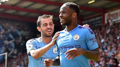 Manchester City's Raheem Sterling celebrates scoring his team's second goal with teammate Bernardo Silva. AFP
