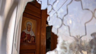 A shattered window at St George’s Greek Orthodox Church, where gunmen carried out a deadly attack at a funeral. Reuters