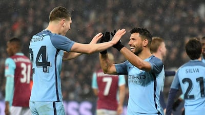 John Stones, left, and Sergio Aguero both got on the scoresheet in Manchester City's 5-0 victory over West Ham United in the FA Cup on Friday night. Justin Tallis / AFP