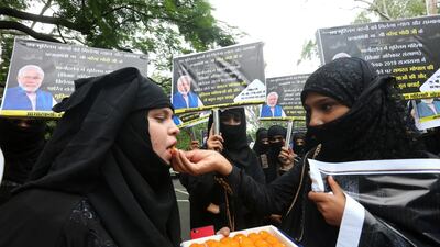 Indian Muslim women offer sweets to each other as they celebrate passing a law outlawing instant divorce for Muslims, in Bhopal, India, 31 July 2019. EPA