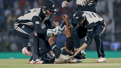 New Zealand's Ish Sodhi, down, celebrates the wicket of India's Ravindra Jadeja during the ICC World Twenty20 2016 cricket match at the Vidarbha Cricket Association stadium in Nagpur, India, Tuesday, March 15, 2016. (AP Photo/Saurabh Das)