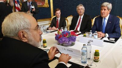 Iran's foreign minister Javad Zarif, left, holds a meeting with US secretary of state John Kerry, right, in Vienna last year. In the forthcoming Camp David summit, the Americans are likely to point out that such negotiations are the only viable means short of a conflict to prevent Iran from gaining nuclear weapons. Jim Bourg / Reuters