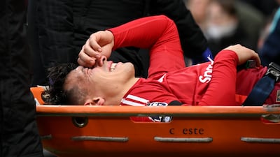 United defender Lisandro Martinez is carried off the pitch on a stretcher after picking up what looked like a serious knee injury. Getty Images