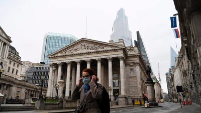 A pedestrian walks past the Bank of England in the City of London. The BoE has ensured the UK banking system “remains resilient” against any serious financial shocks and can continue lending to businesses and households. AFP
