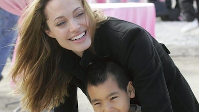 Angelina Jolie talks to her son Maddox, her adopted child from Cambodia. AP
