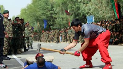 Afghan security officials attend a ceremony to mark Independence Day, in Kandahar, Afghanistan. Afghanistan is celebrating the 97th anniversary of its independence from British rule. Muhhamad Sadiq / EPA