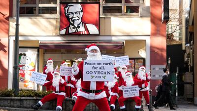 Activists from the People for the Ethical Treatment of Animals channel the Christmas spirit for a protest outside a KFC branch in Tokyo, urging to chain to offer vegan options. EPA