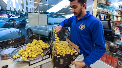 A date seller prepares his fruit for sale. Dates are customarily eaten to break the fast each day during Ramadan