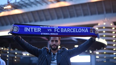 A fan poses for a photograph outside the stadium. Reuters