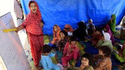Displaced Pakistani children attend a class in a makeshift school established by Unicef at the Jala refugee camp in Mardan.