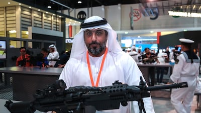 Hamad Al Ameri, chief executive of Caracal, with the new Caracal light machinegun that was unveiled at the International Defence Exhibition. Victor Besa / The National