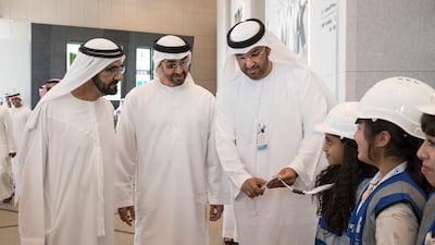 Sheikh Mohammed bin Rashid, Vice President and Ruler of Dubai and Sheikh Mohammed bin Zayed, Crown Prince of Abu Dhabi and Deputy Supreme Commander of the UAE Armed Forces, and Dr Sultan Al Jaber, Minister of State, chairman of Masdar and chief executive of Adnoc Group, greet children of Abu Dhabi National Oil Company employees while visiting the Adnoc headquarters. Ryan Carter / Crown Prince Court - Abu Dhabi )---
