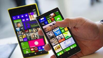 The Nokia Oyj Lumia 1520, left, and Nokia Lumia Icon smartphones are displayed at the Microsoft Developers Build Conference in San Francisco this month. Microsoft is adding a voice-controlled digital assistant called Cortana to its Windows Phone software, seeking to match a feature that's already available in Apple and Google smartphones. David Paul Morris / Bloomberg