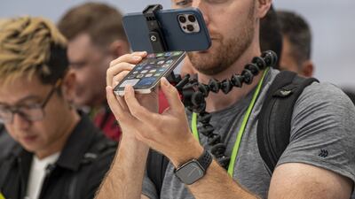 An attendee takes a closer look at the Apple iPhone 15 Pro during an event at Apple Park campus in Cupertino, California on September 12. Despite now-incremental improvements in technology, Apple's devices still sell in the millions. Bloomberg