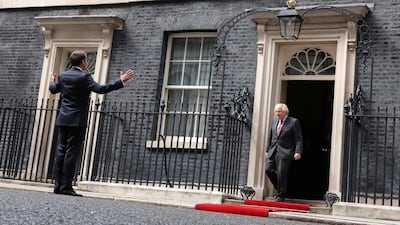 French President Emmanuel Macron is greeted by Britain's Prime Minister Boris Johnson outside 10 Downing Street in central London. AFP