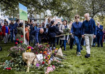 People lay flowers and candles at monument near the health centre in Rotterdam. EPA