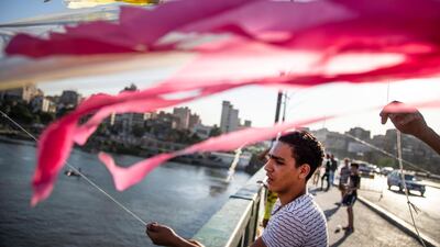A man pulls a kite to let it fly on a bridge over the Nile River in Cairo, Egypt. EPA