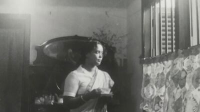 The contributor's grandmother by the table.