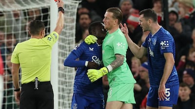 Everton's Idrissa Gueye is shown a red card after slapping teammate Michael Keane, right. Reuters