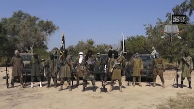 Boko Haram leader Abubakar Shekau is seen surrounded by his fighters in this still from a video released by the group on October 31, 2014. AP