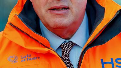 Britain's Prime Minister Boris Johnson looks on during a visit to a construction site for the new High Speed 2 (HS2) rail project in Birmingham, England on February 11. Mr Johnson's cabinet have green-lit the high-speed rail line, despite the huge cost prediction and opposition from environmentalists. Eddie Keogh / Pool via AP