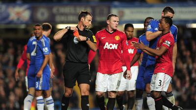 Referee Mark Clattenburg puts his red card away after sending off Chelsea's Branislav Ivanovic at Stamford Bridge. Shaun Botterill/Getty Images