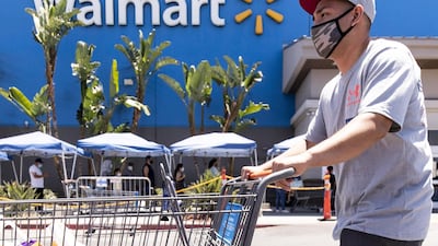 A Walmart shopper wears a mask as protection against the coronavirus as he leaves the supermarket in Burbank, California. The retailer announced it will require customers nationwide to wear face masks inside their stores from July20. EPA