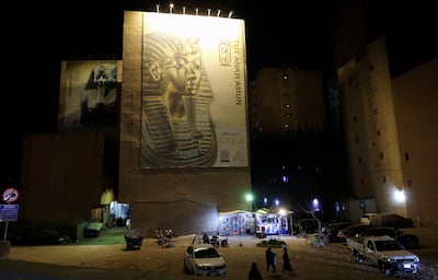 The mask of King Tutankhamun is displayed on a road leading to the museum. Reuters