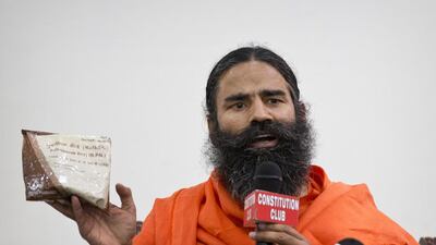 Indian yoga guru Baba Ramdev displays a packet of his medicine on May 1, 2015. Saurabh Das/AP Photo