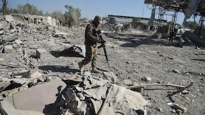 An Afghan security personnel investigates the site of a Taliban car bomb attack in Kabul on July 2. AFP / Wakil Kohsar