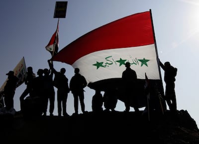 Demonstrators wave a giant national flag during an anti-government protest in Fallujah city on January 4, 2013. Corruption has been a long-running problem in Iraq. EPA