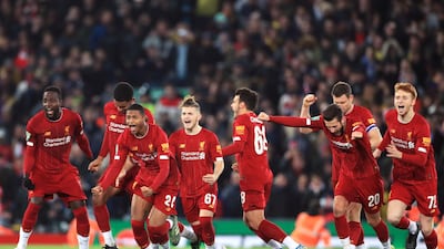 Liverpool players celebrate after winning the penalty shootout. PA