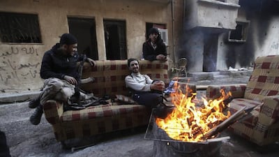 Free Syrian Army fighters sit around a fire in Deir Al Zor, eastern Syria. Those joining the battle against Bashar Al Assad include Western Muslims, reportedly from the UK, France, the United States, Canada, Australia and Scandinavia. Khalil Ashawi / Reuters