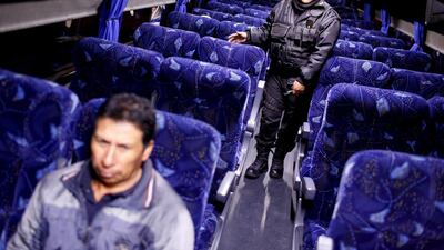 A policeman inspecting a passenger bus at a checkpoint outside the Altiplano federal penitentiary, on the outskirts of Mexico City on July 12, 2015 a day after the second escape of Joaquin 'El Chapo' Guzman, in Almoloya de Juarez. Tomas Bravo/Reuters