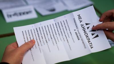 Greek election workers count ballots at a polling station in Athens. AP