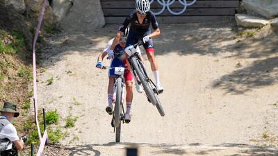 Great Britiain's Tom Pidcock goes airborne ahead of France's Victor Koretzky. AP