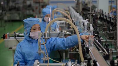 A worker checks bottles of new disinfectant products on a production line at the Ryongaksan Soap Factory in Pyongyang. AFP
